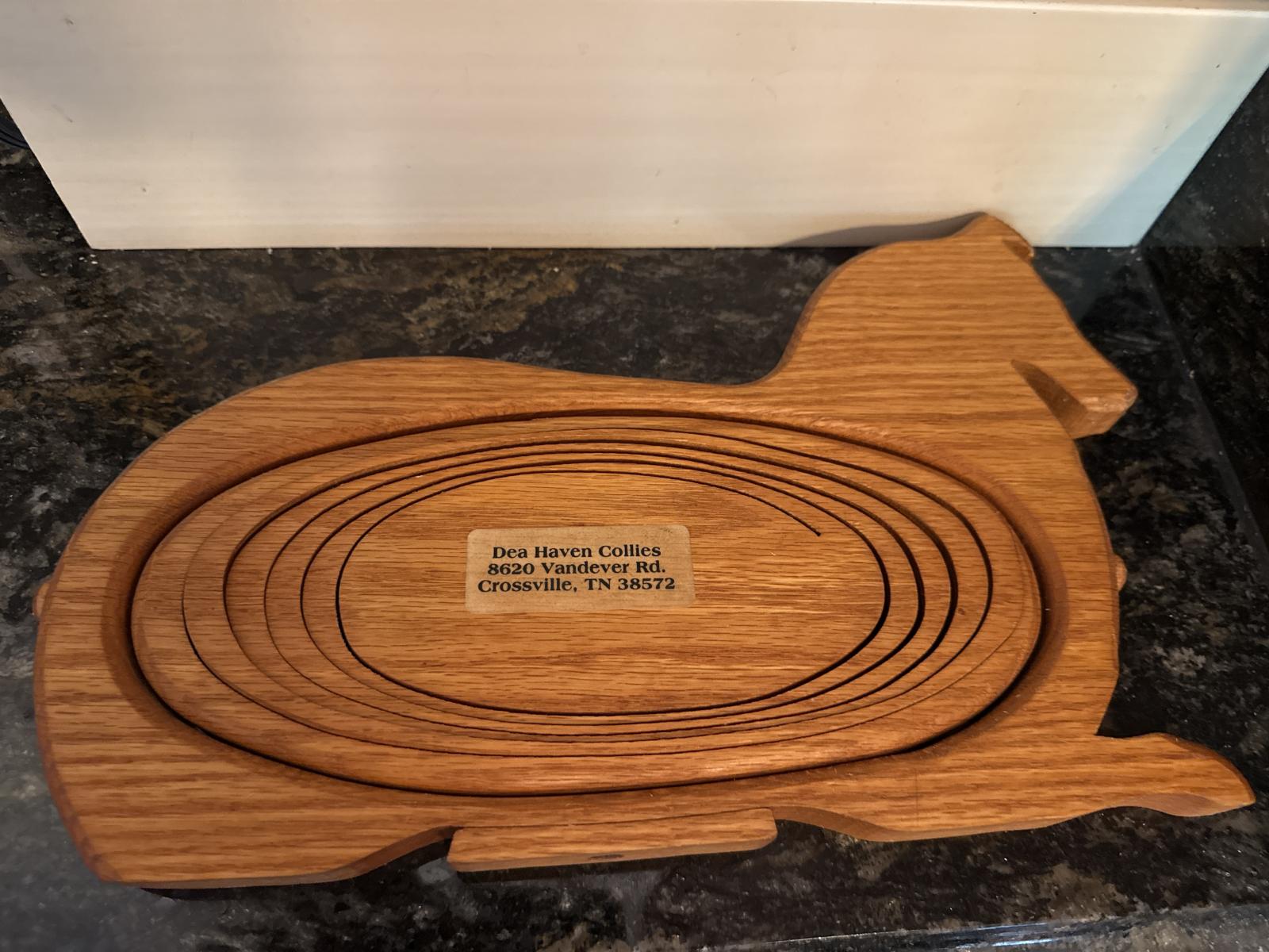 Bottom view of wooden collie basket with maker's mark.