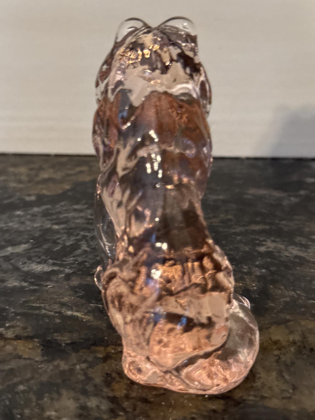 Rear view of pink glass collie statue showing back and tail.
