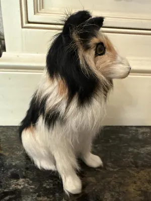 Side view of tricolor collie figurine made from goat fur.