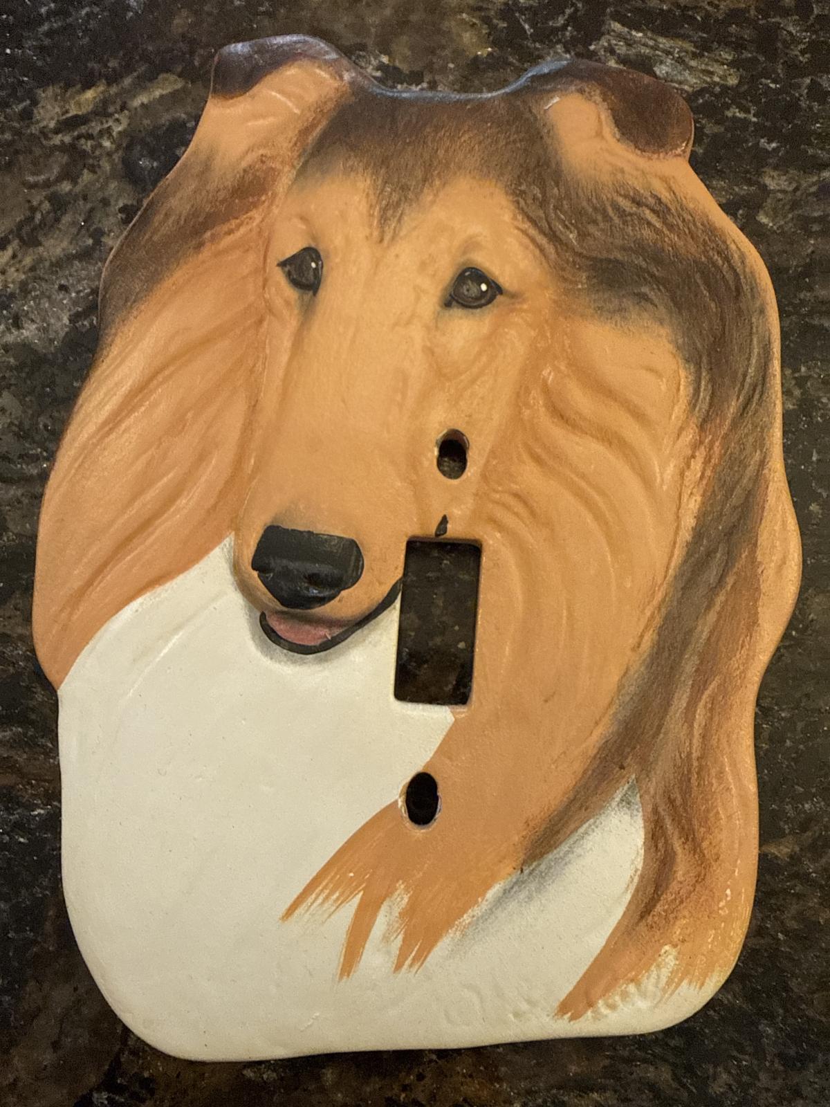 Collie head-shaped ceramic light switch cover, brown and white.