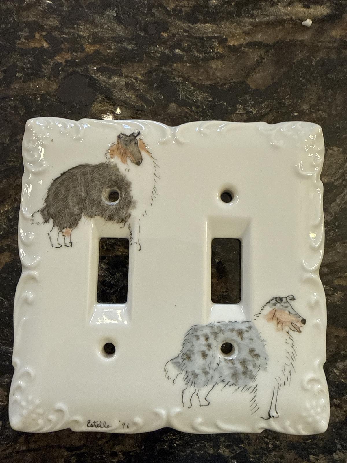 Rectangular ceramic light switch cover with collie illustrations and decorative edges.