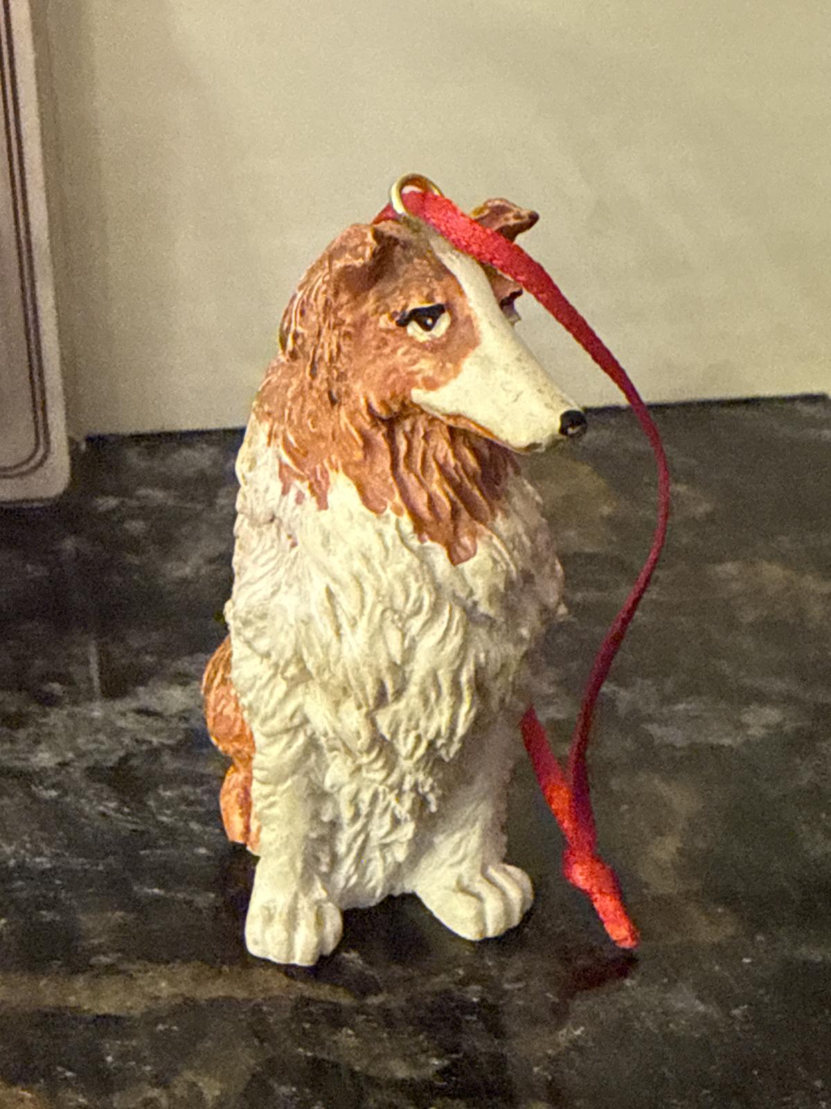 Close-up of second collie dog ornament with red ribbon.