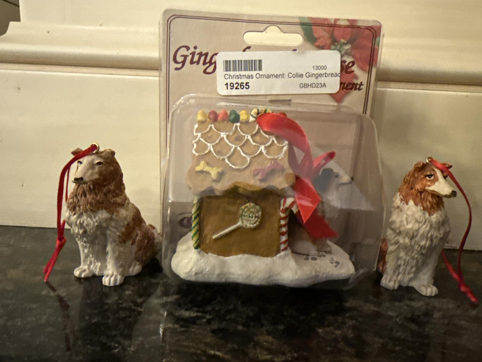 Collie dog ornaments and gingerbread house in packaging.